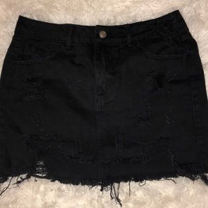 Distressed black jean skirt